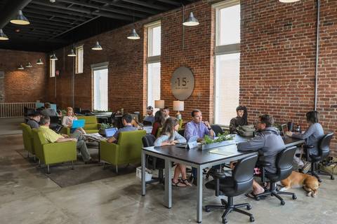 a group of people sitting at a table in front of a building