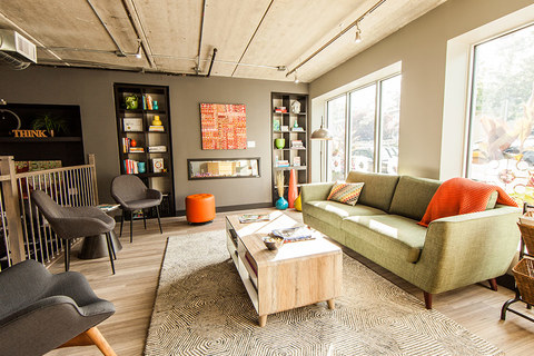 a living room filled with furniture and a large window