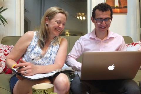 Sergei Lemberg sitting at a table in front of a laptop