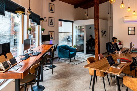 a living area with a desk and chair in a room