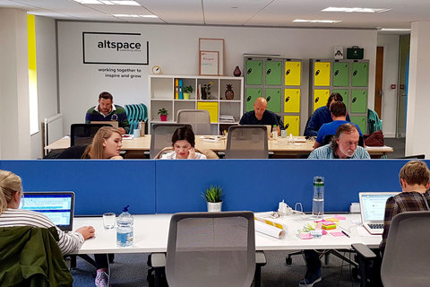 a group of people sitting at a table in front of a mirror