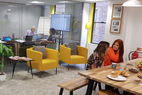 a group of people sitting at a table in a room