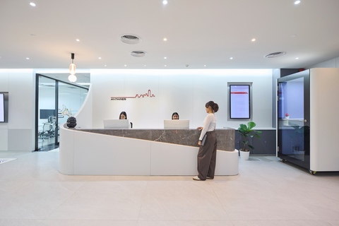 a woman standing at a reception desk