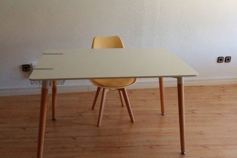 a chair sitting in front of a wooden table