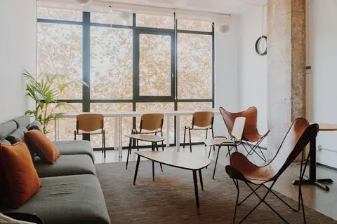 a room with a couch and chairs