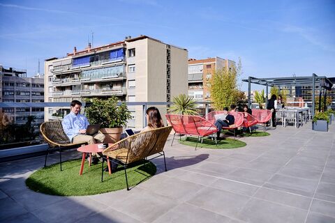 a group of people sitting on a bench in front of a building