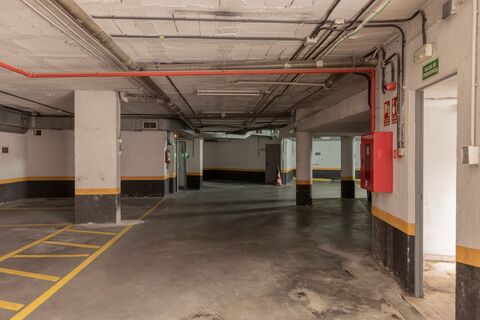 a parking garage with a red fire extinguisher
