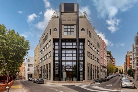a building with a clock on the side of a road