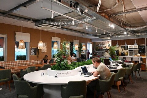 a room with people sitting at a table