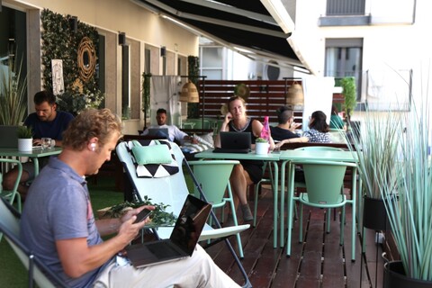 a group of people sitting at a table with a laptop
