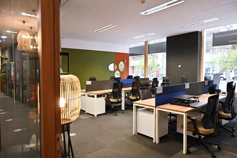 an office with a desk and chair in a room