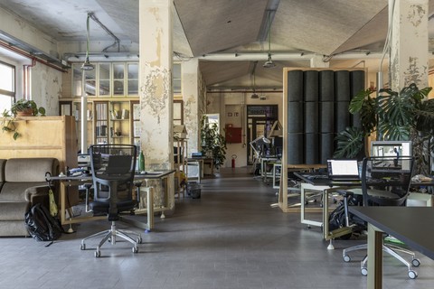 a room filled with furniture and a table in front of a building