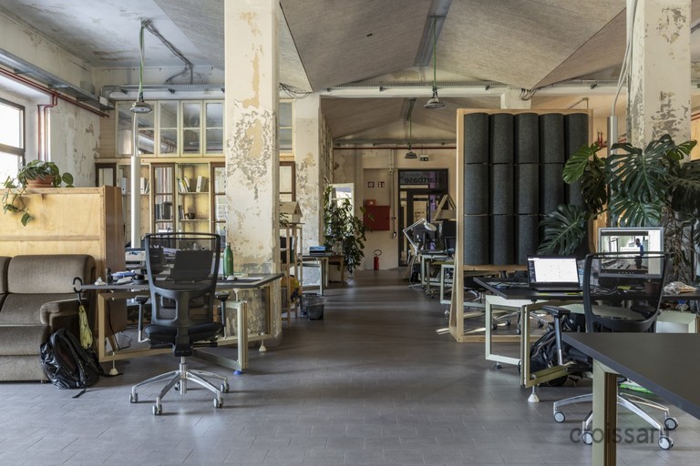 a room filled with furniture and a table in front of a building