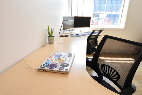 a desk with a computer on a table