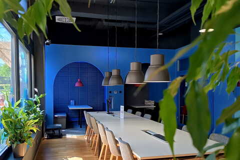a room with a long table and chairs