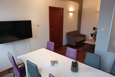 a room with a tv and a table
