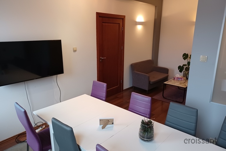 a room with a tv and a table