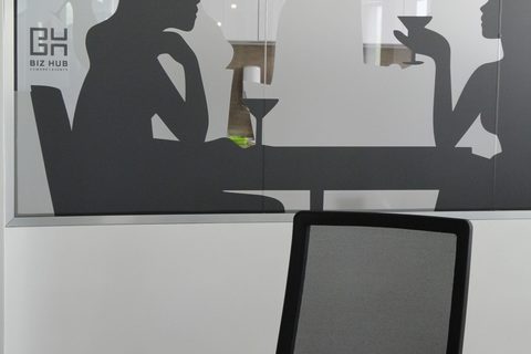a person sitting at a desk in front of a mirror