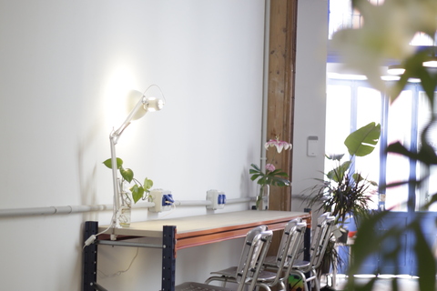 a room filled with furniture and vase of flowers on a table