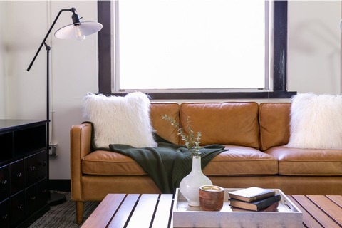 a living room filled with furniture and a large window