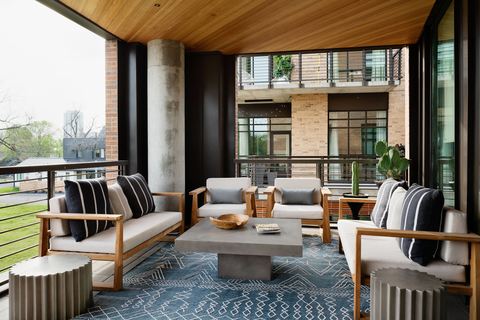 a living room filled with furniture and a large window