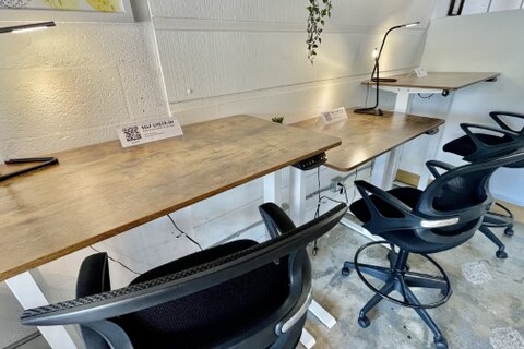 a desk with a computer in an office chair