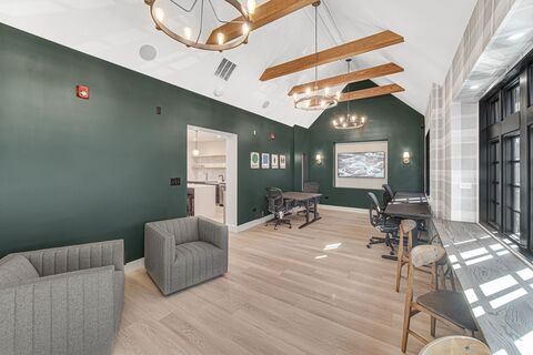 a room with a green wall and a table and chairs