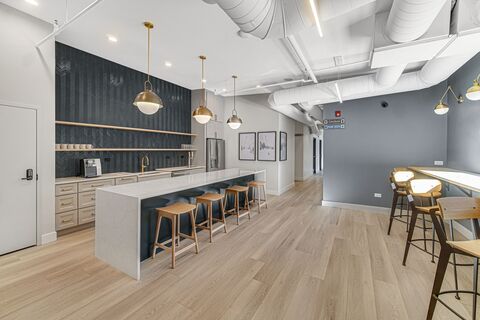 a kitchen with stools and a bar