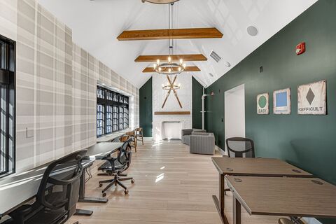 a room with a fireplace and tables