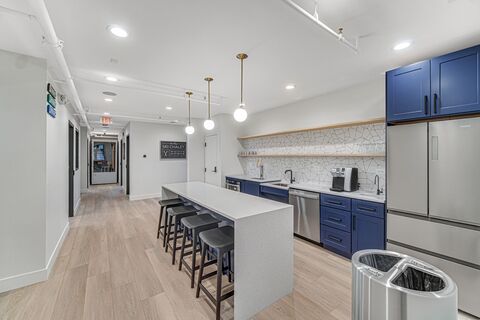 a kitchen with a counter and stools
