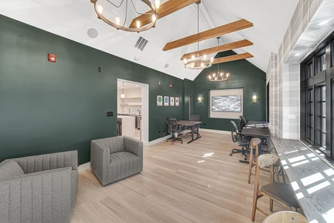 a room with a green wall and a table and chairs