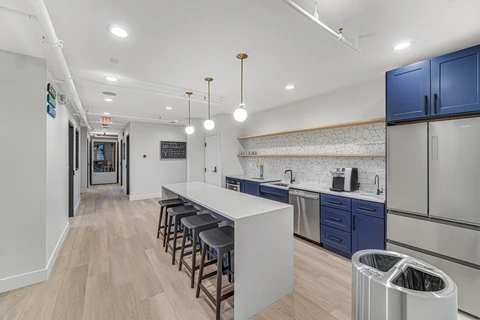 a kitchen with a counter and stools