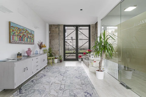a room with a glass door and plants