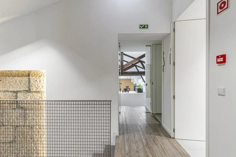 a hallway with a metal fence and a door