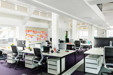 an office with a desk and chair in a room