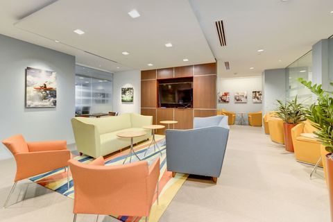 a living room filled with furniture and a large window