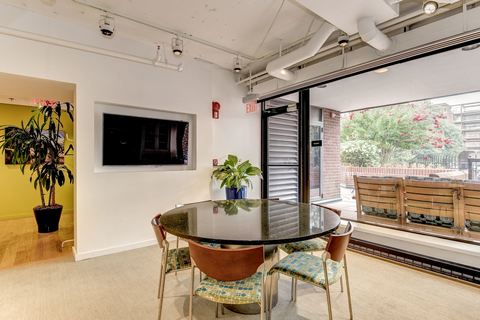 a living room filled with furniture and a large window