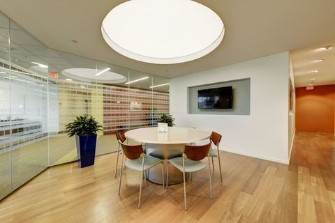 a living room filled with furniture on top of a hard wood floor
