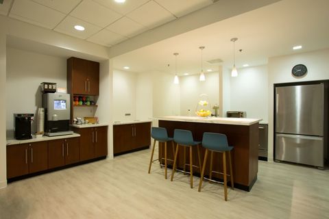 a kitchen with a wood floor in a room