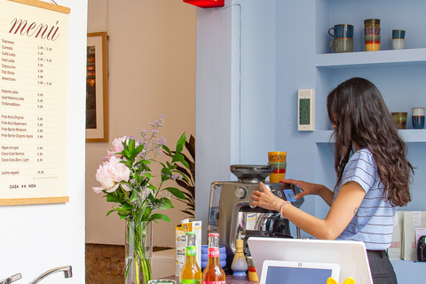 a woman making coffee in a coffee machine