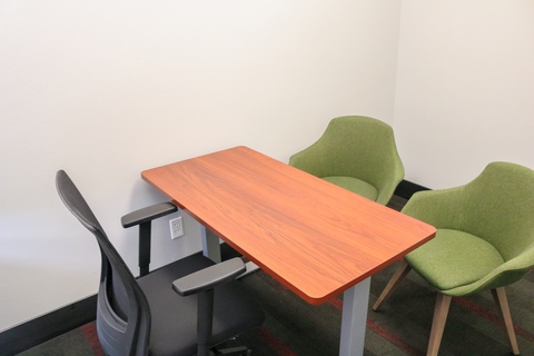 a chair sitting in front of a wooden table