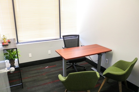 a desk with a chair in a room