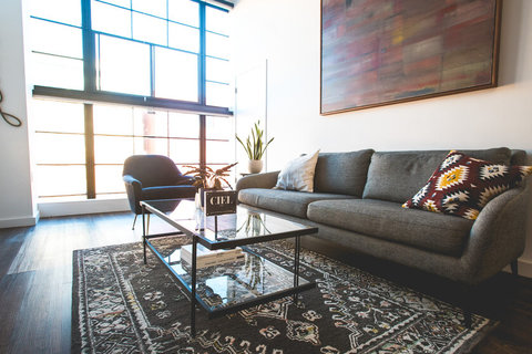 a living room filled with furniture and a large window