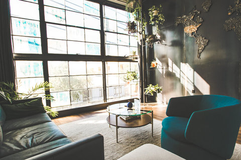 a living room filled with furniture and a large window