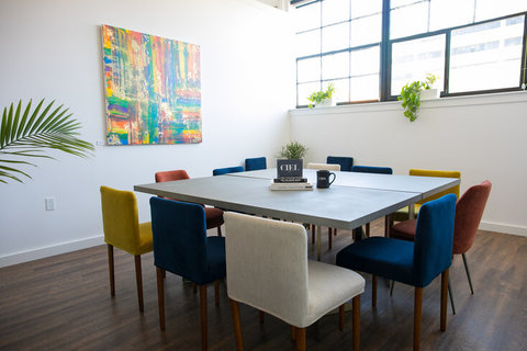 a kitchen with a table and chairs in a room