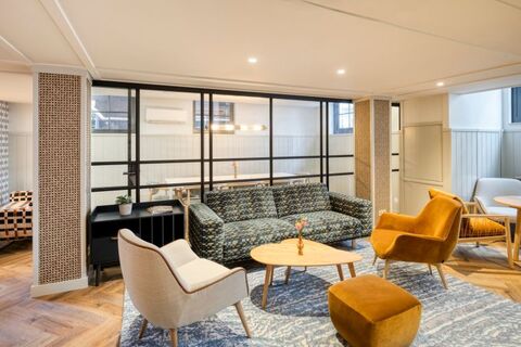 a living room filled with furniture and a large window