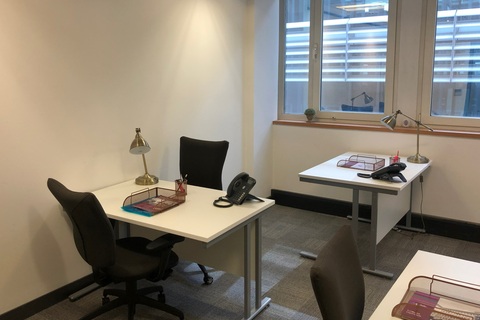 a room filled with furniture and a large window