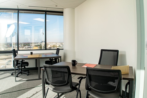 a dining room table in front of a window