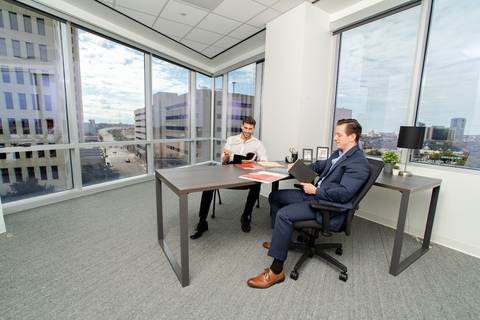 a person sitting in a chair in front of a window