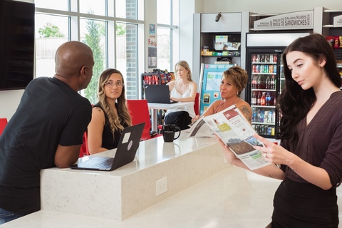 a group of people sitting at a table in front of a box